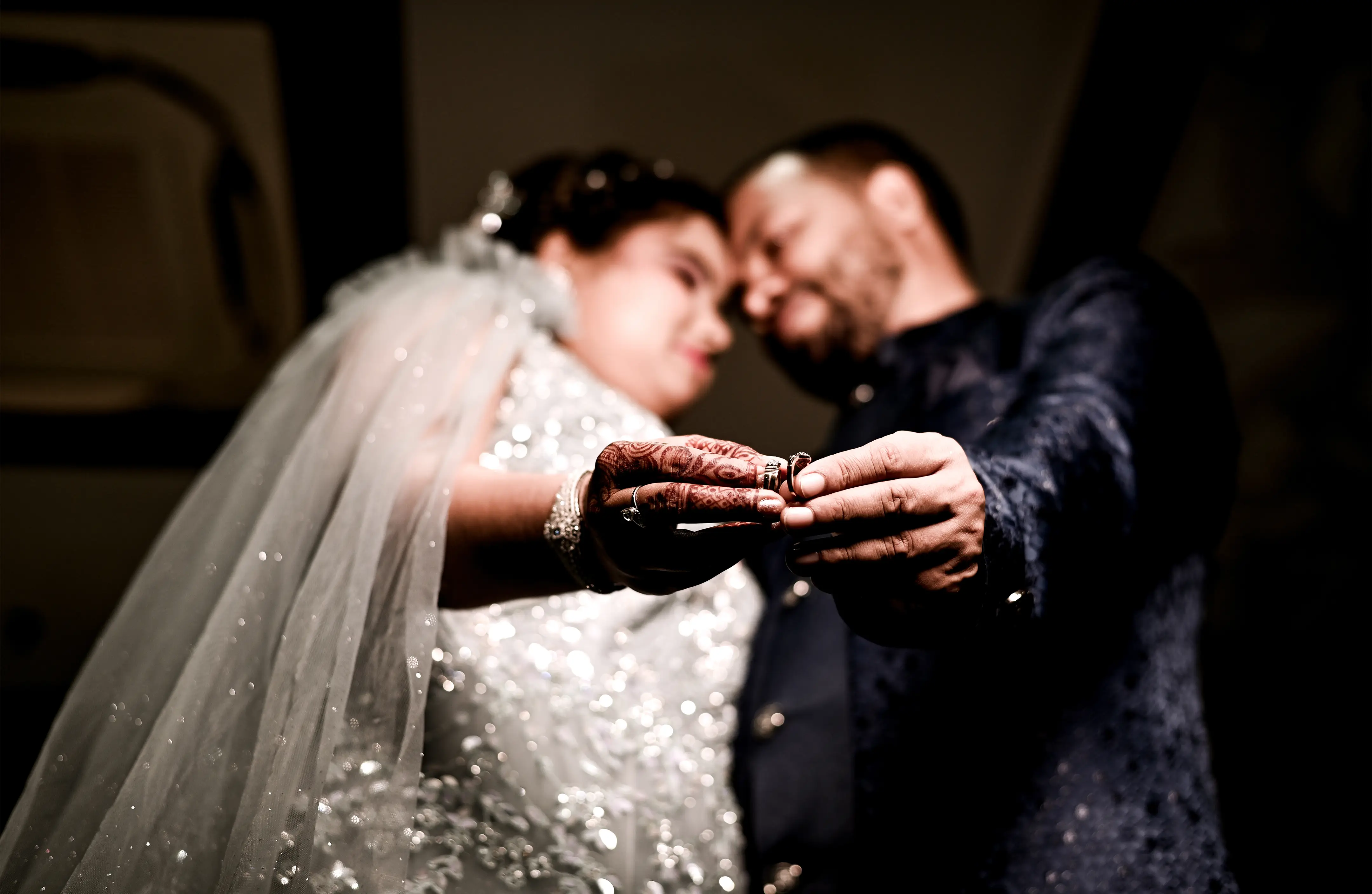 Romantic couple exchanging rings during their engagement, captured by DesignInfo Photography